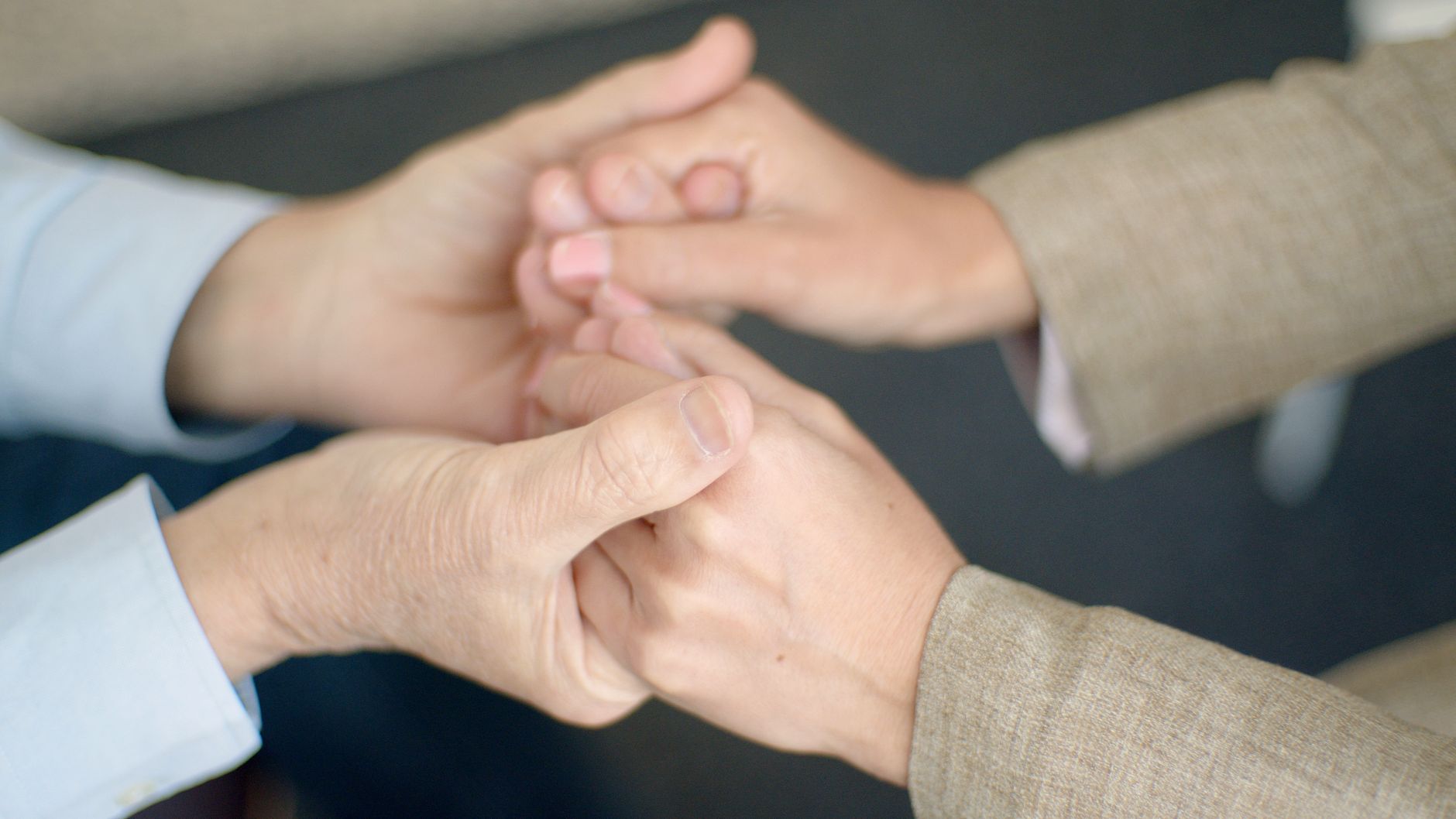 close up of woman and man holding hands
